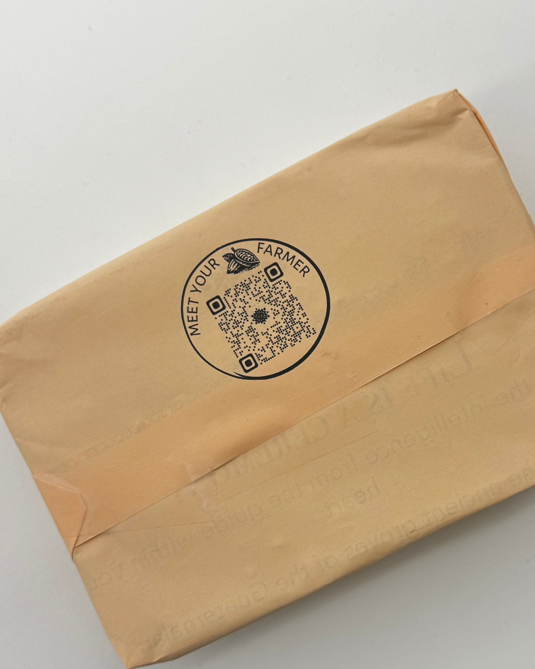 Brown paper bag with 'Meet Your Farmer' logo on a light gray background